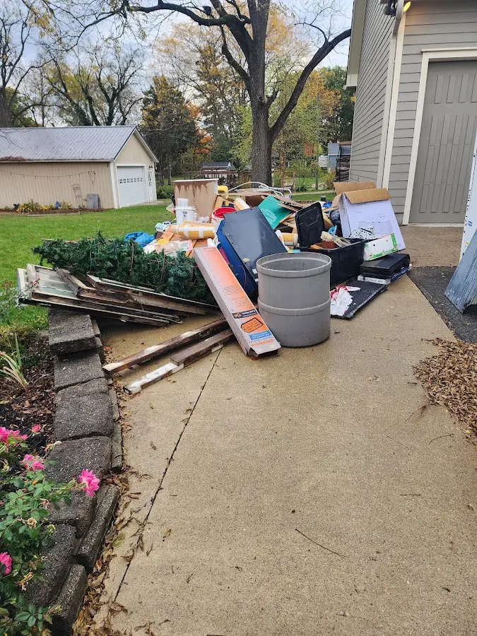 Dumpster being loaded with debris for Commercial Dumpster Rental in McLoud
